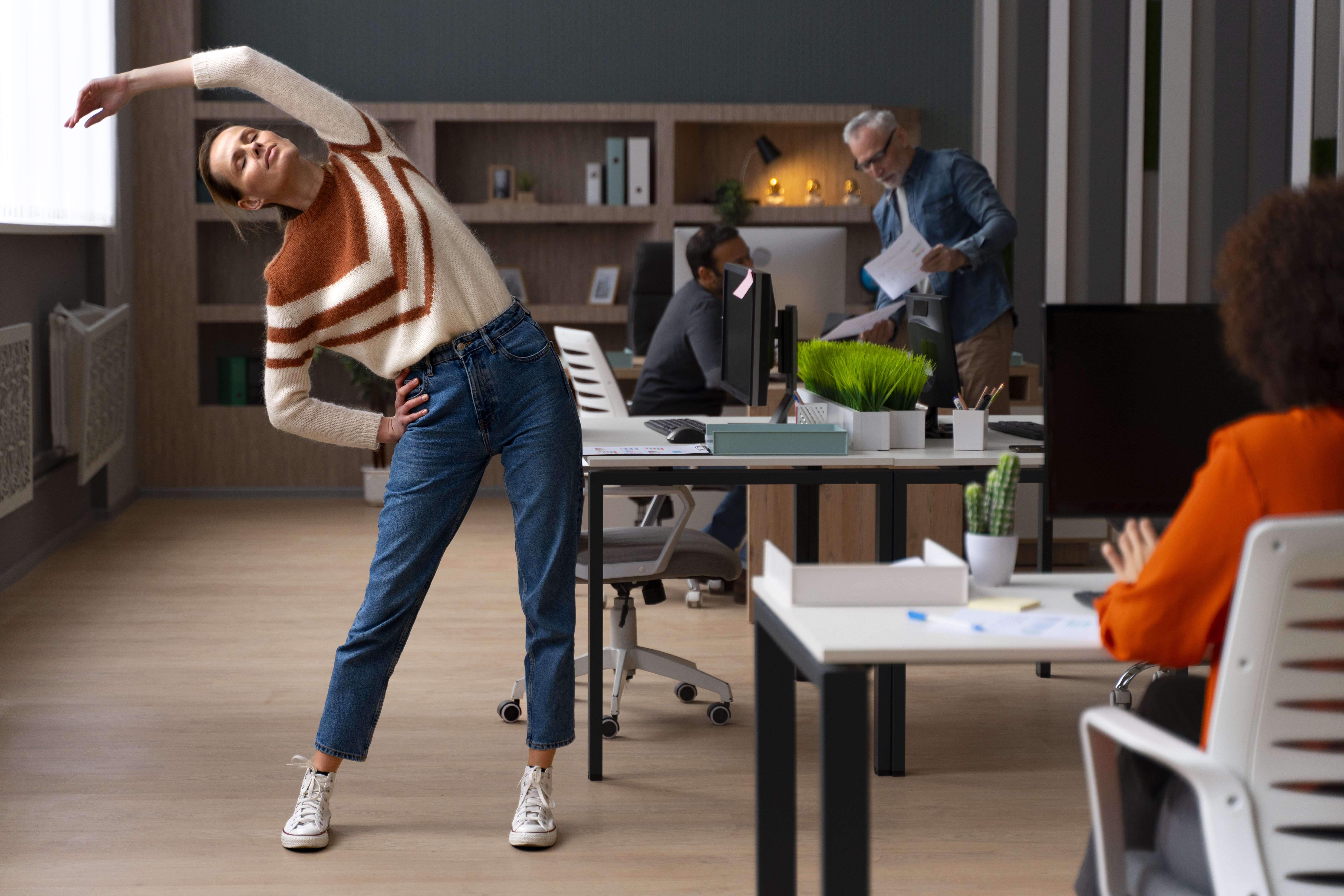 Person stretching at their desk during a work break