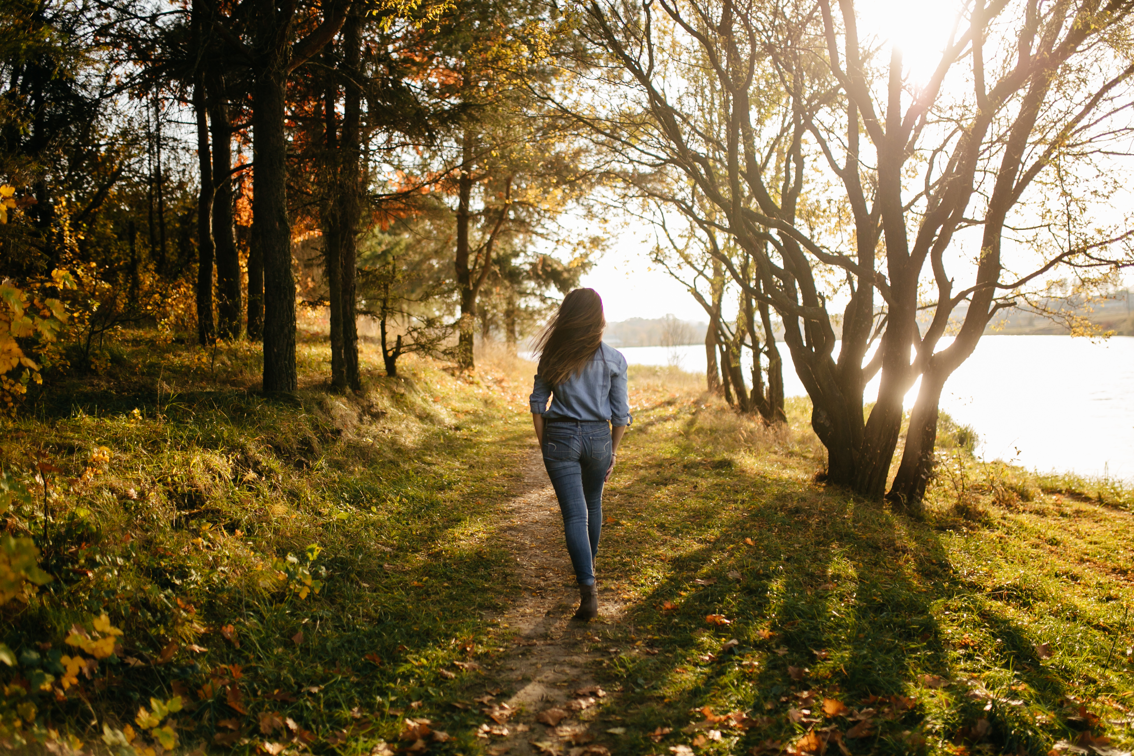 Taking Breaks Outdoors Improves Mental Clarity  Woman walking in nature, enjoying a break from digital screens